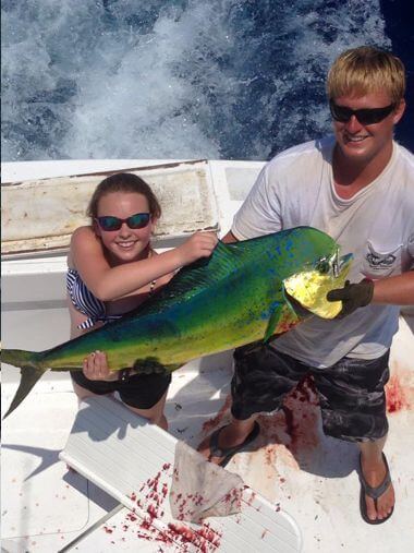Young lady staying in Buxton NC proudly displays her big mahi mahi.